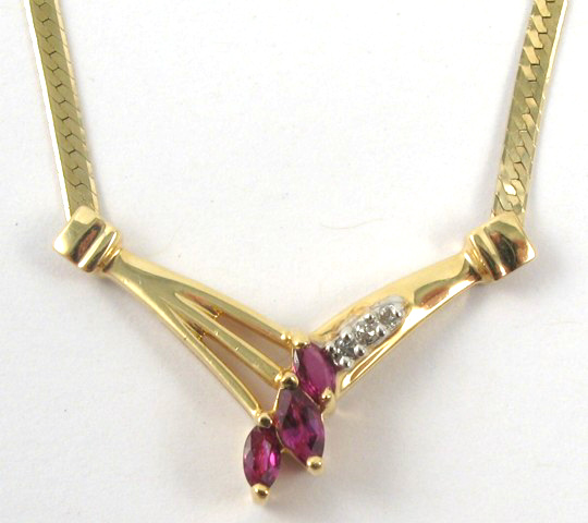 Appraisal: GARNET AND DIAMOND PENDANT NECKLACE the V-shaped pendant is suspended