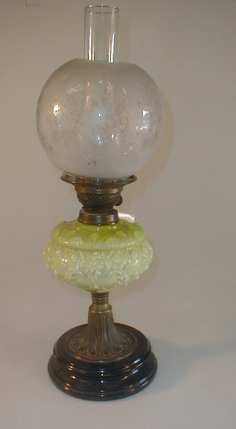 Appraisal: An early thC oil lamp with a double burner green