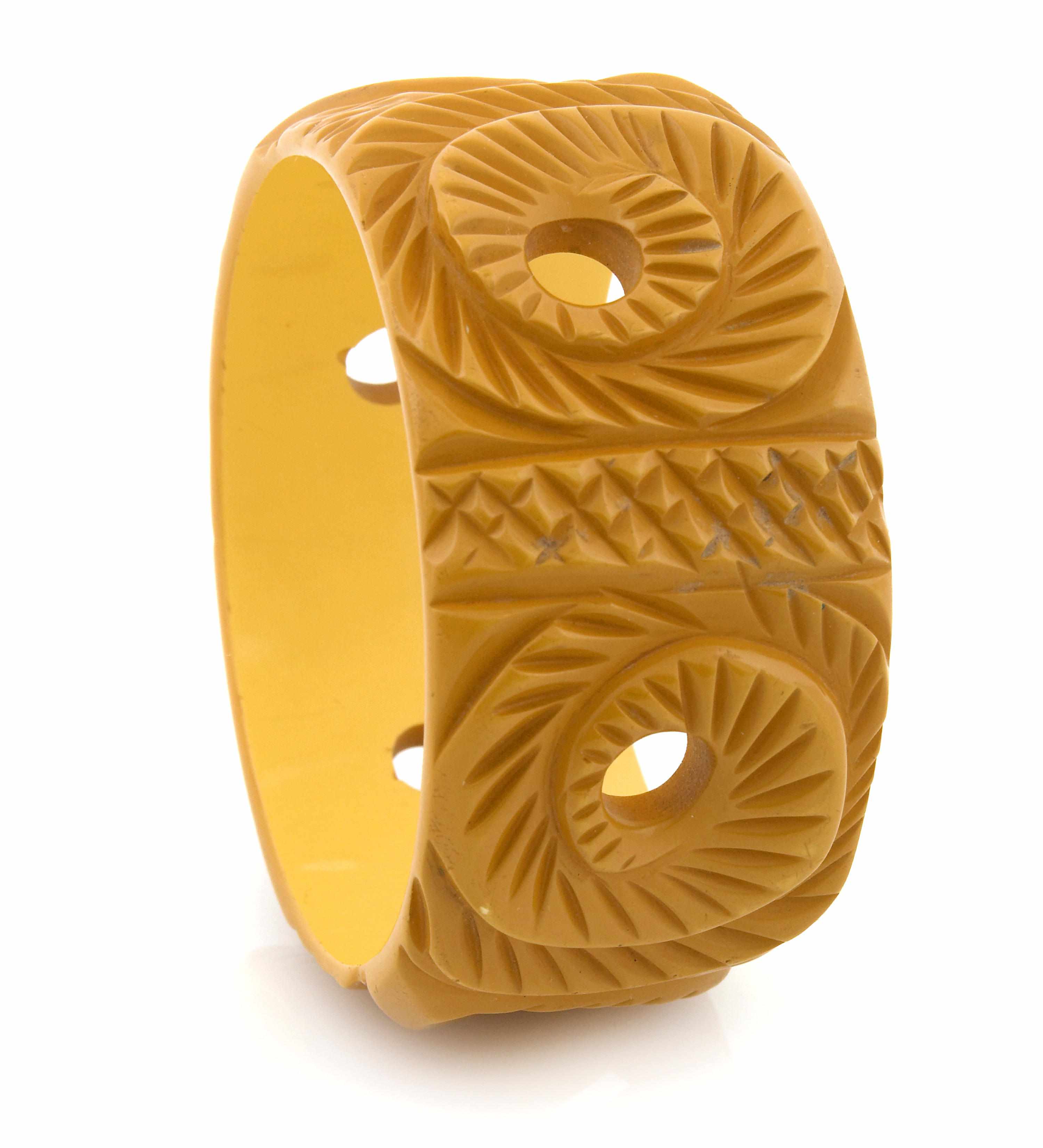 Appraisal: A deeply carved and pierced butterscotch foliate Bakelite bangle bracelet