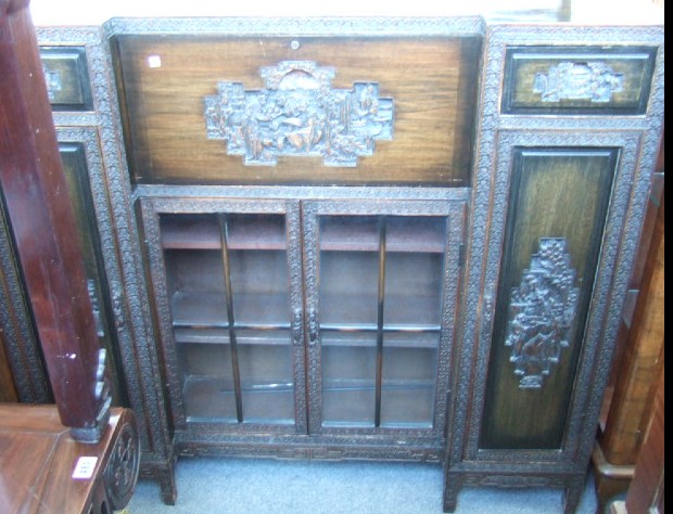 Appraisal: A Chinese carved and stained hardwood side cabinet of reverse