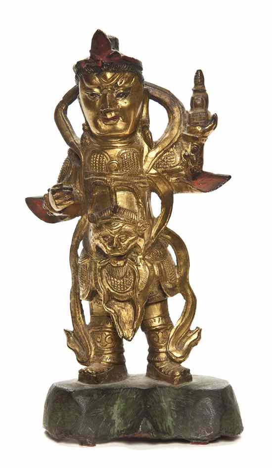 Appraisal: A Chinese Gilt Bronze Figure of Zhenwu depicted standing on