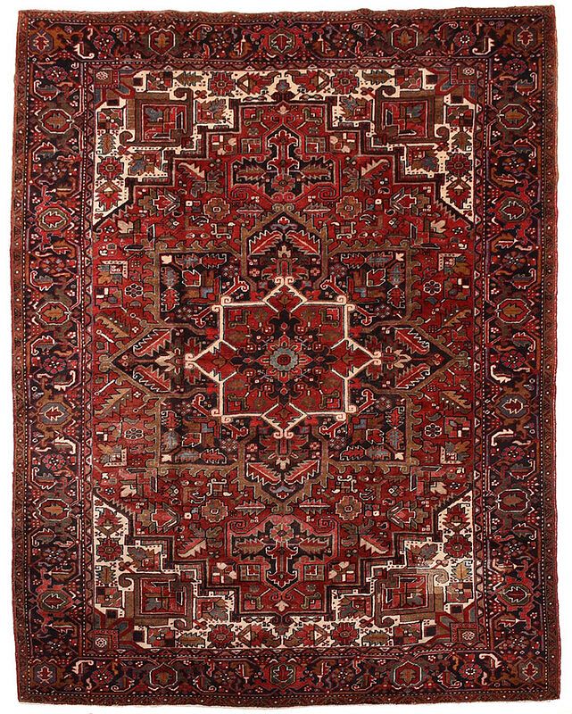 Appraisal: Heriz Carpet th century red field central polygonal medallion spandrels