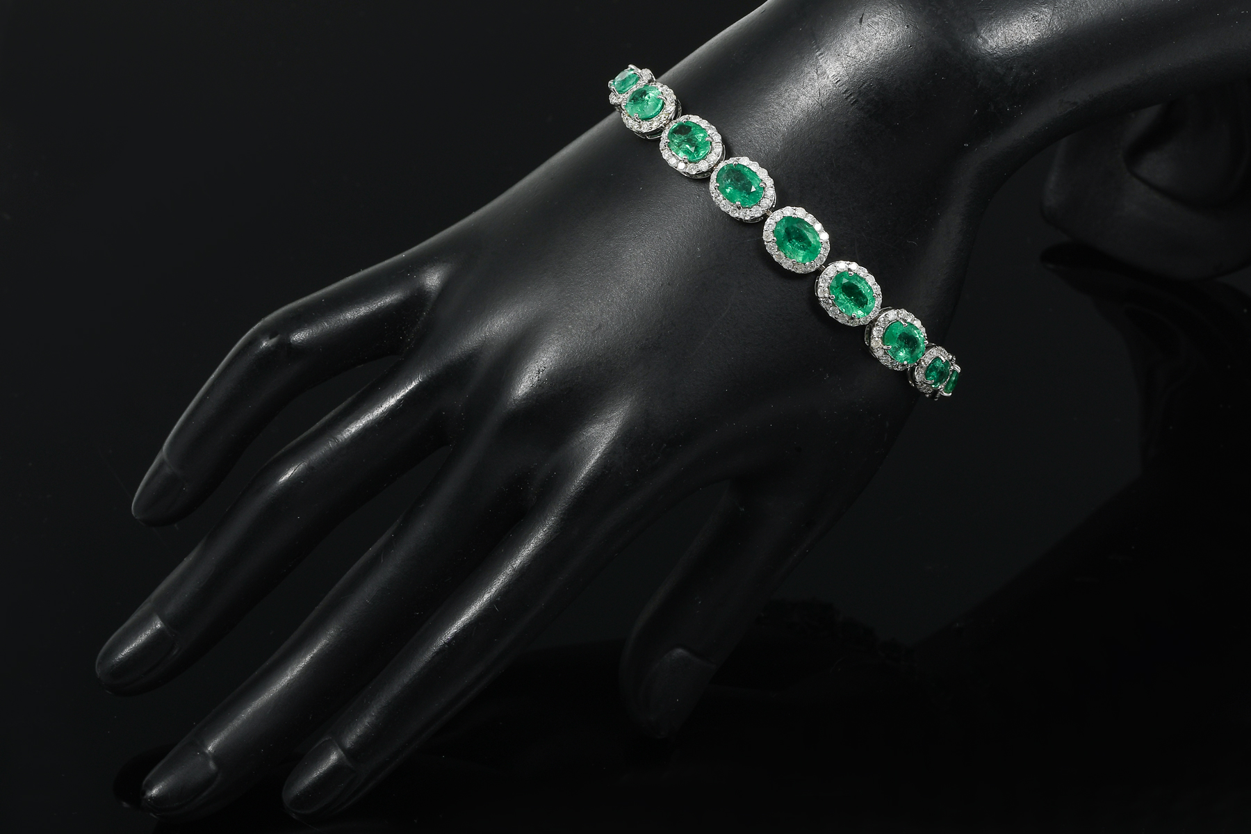 Appraisal: K EMERALD DIAMOND BRACELET faceted emeralds are each set within