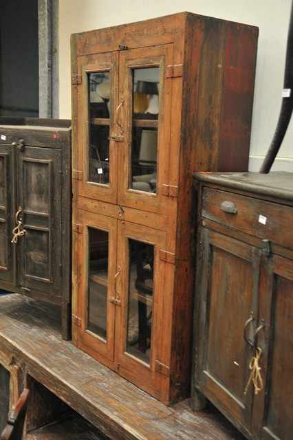 Appraisal: A RUSTIC INDIAN CABINET WITH GLAZED DOORS