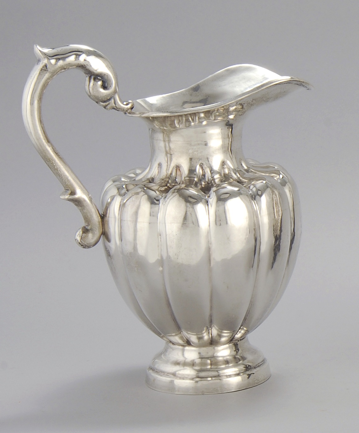 Appraisal: MEXICAN HAND-HAMMERED SILVER PITCHER BY MACIEL In melon-form with applied