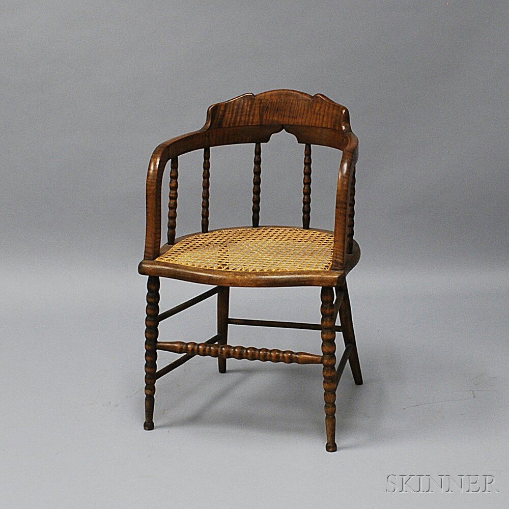 Appraisal: Caned Tiger Maple Armchair late th century the curved and