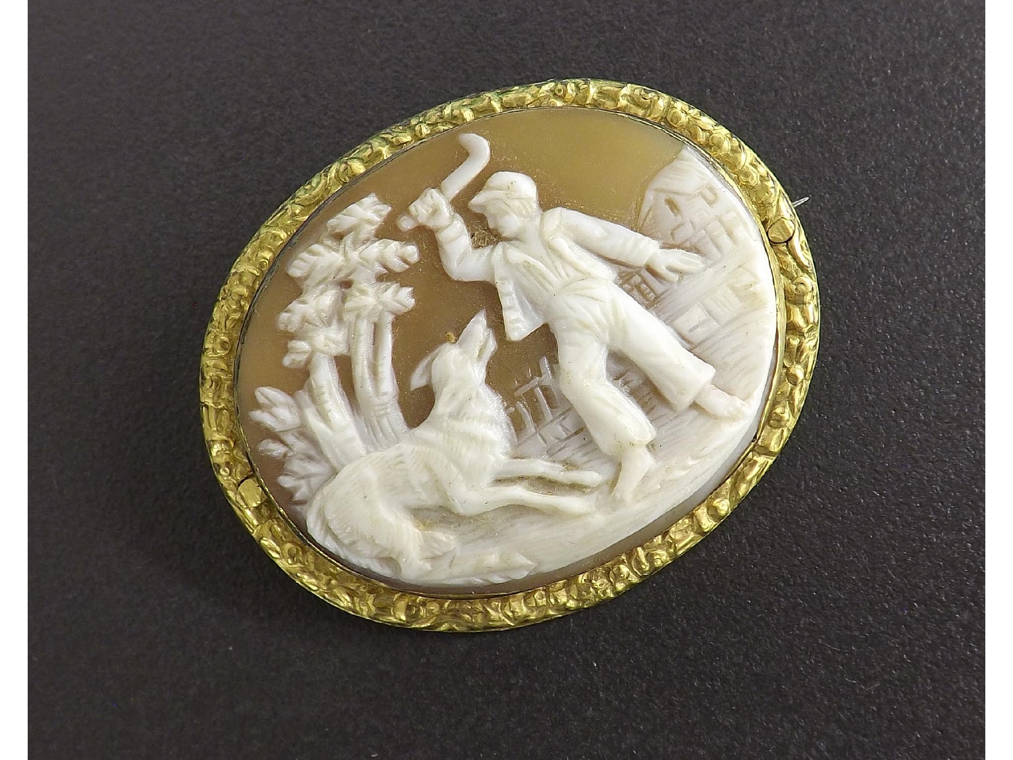 Appraisal: Carved shell cameo brooch depicting a woodsman and a wolf