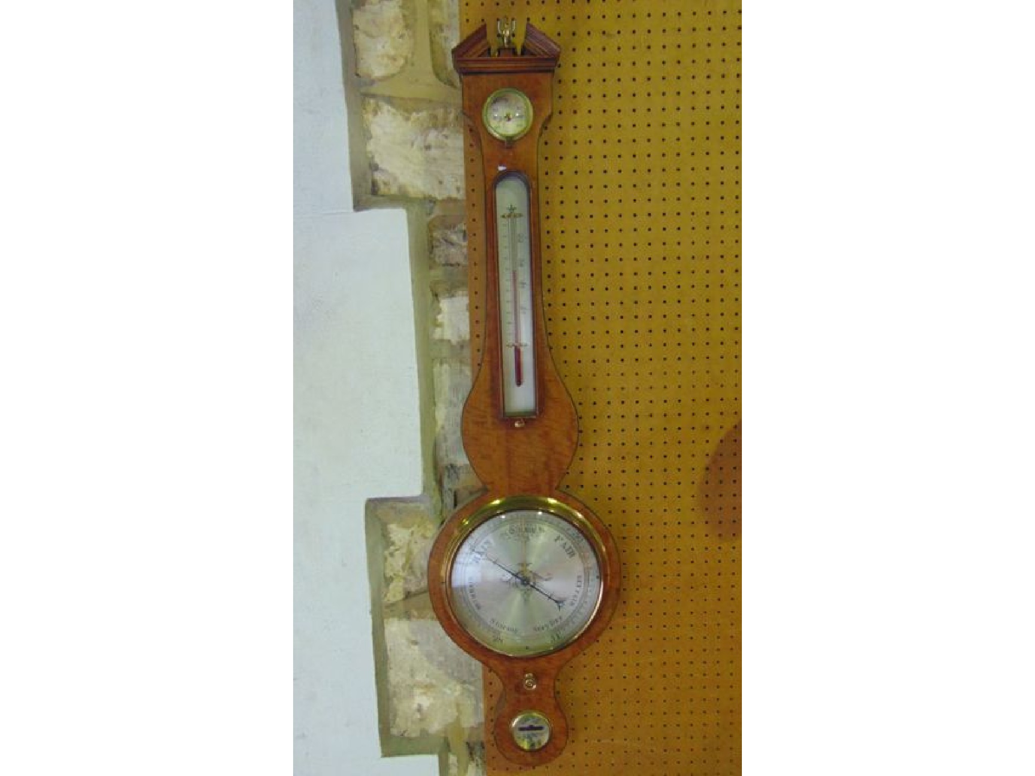 Appraisal: A th century satinwood cased wheel barometer with silvered dials