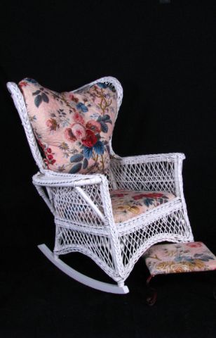 Appraisal: White painted antique wicker rocker with chintz cushions and footstool