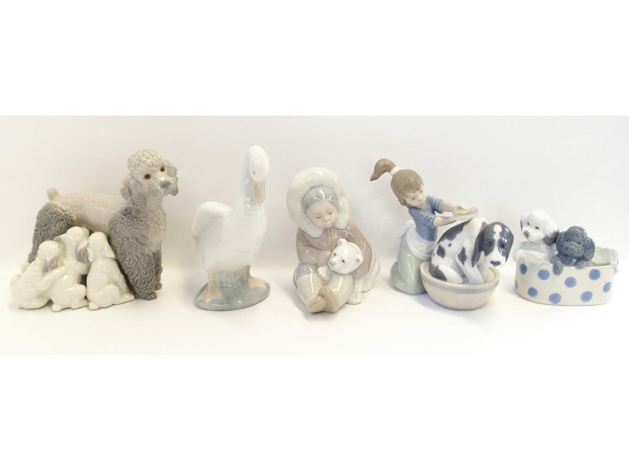 Appraisal: Three Lladro figure including a Poodle and puppies Eskimo boy