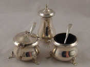 Appraisal: A three piece sterling silver cruet with blue glass liners