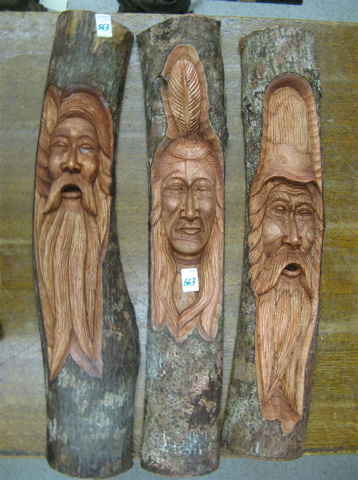 Appraisal: THREE NATIVE WOOD SCULPTURES each a relief-carved bust emerging from