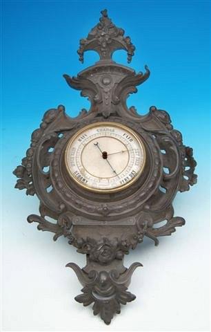 Appraisal: A VICTORIAN CAST METAL ANEROID BAROMETER the decorative shaped case