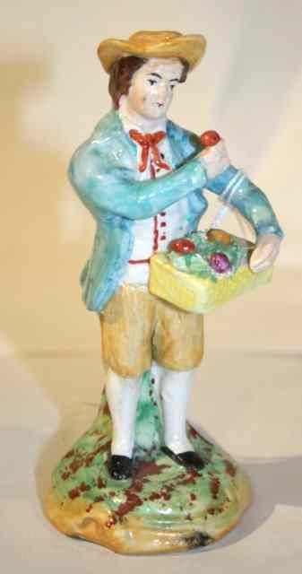 Appraisal: A TH CENTURY STAFFORDSHIRE FIGURE of a flower vendor standing