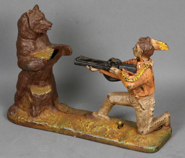 Appraisal: s Book of Knowledge Indian Shooting Bear cast iron mechanical