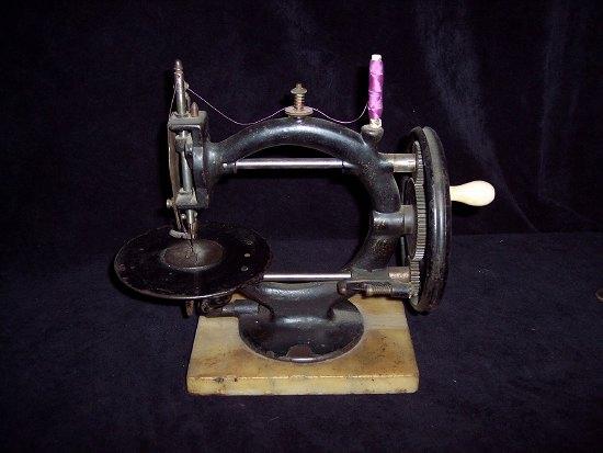 Appraisal: A sewing machine with turned handle on a rectangular marble