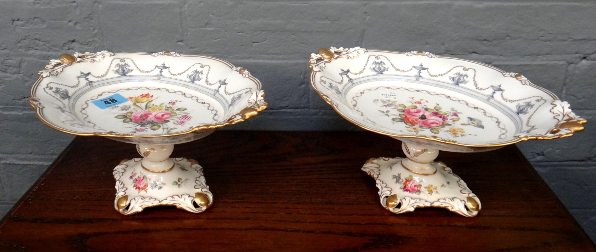 Appraisal: A pair of Royal Crown Derby fruit comports painted with