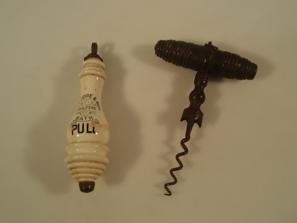 Appraisal: A thC corkscrew with a turned fruit wood handle brush