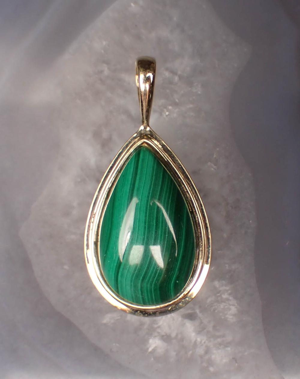 Appraisal: MALACHITE AND FOURTEEN KARAT GOLD PENDANT The yellow gold pendant