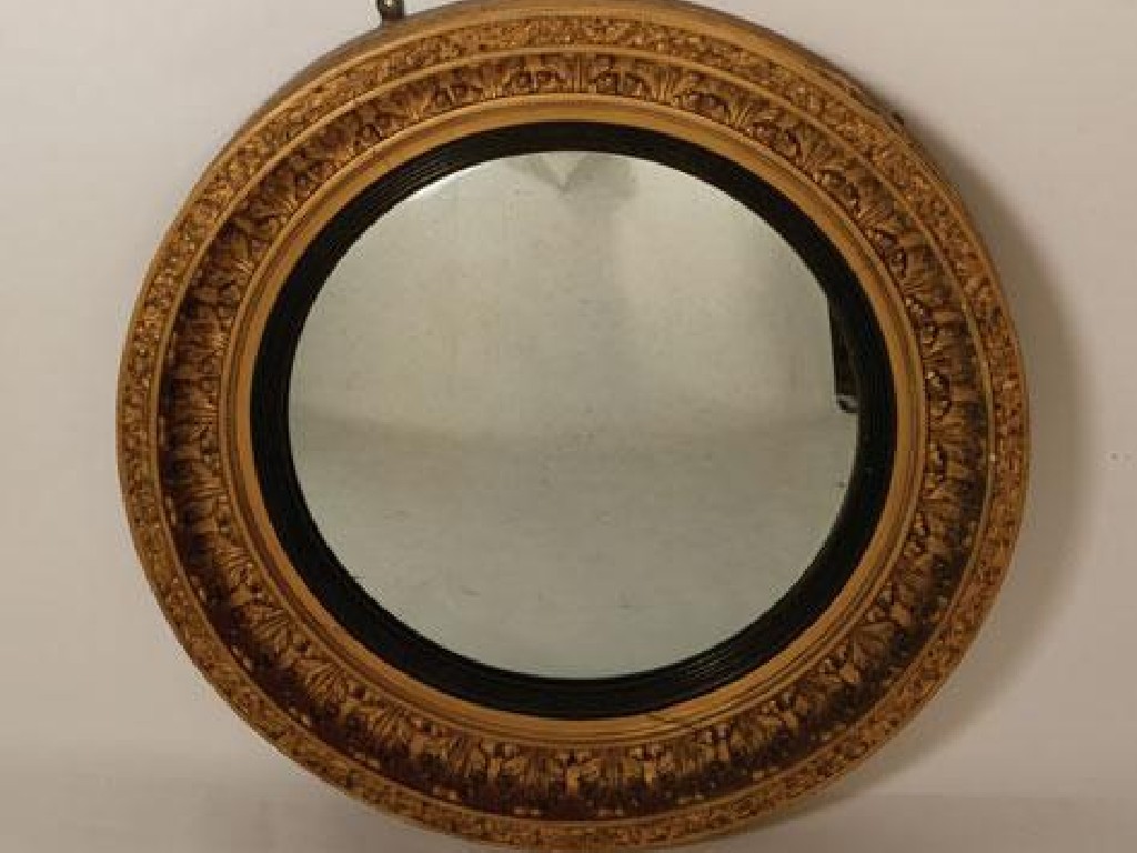 Appraisal: A REGENCY CONVEX WALL MIRROR the circular plate within an