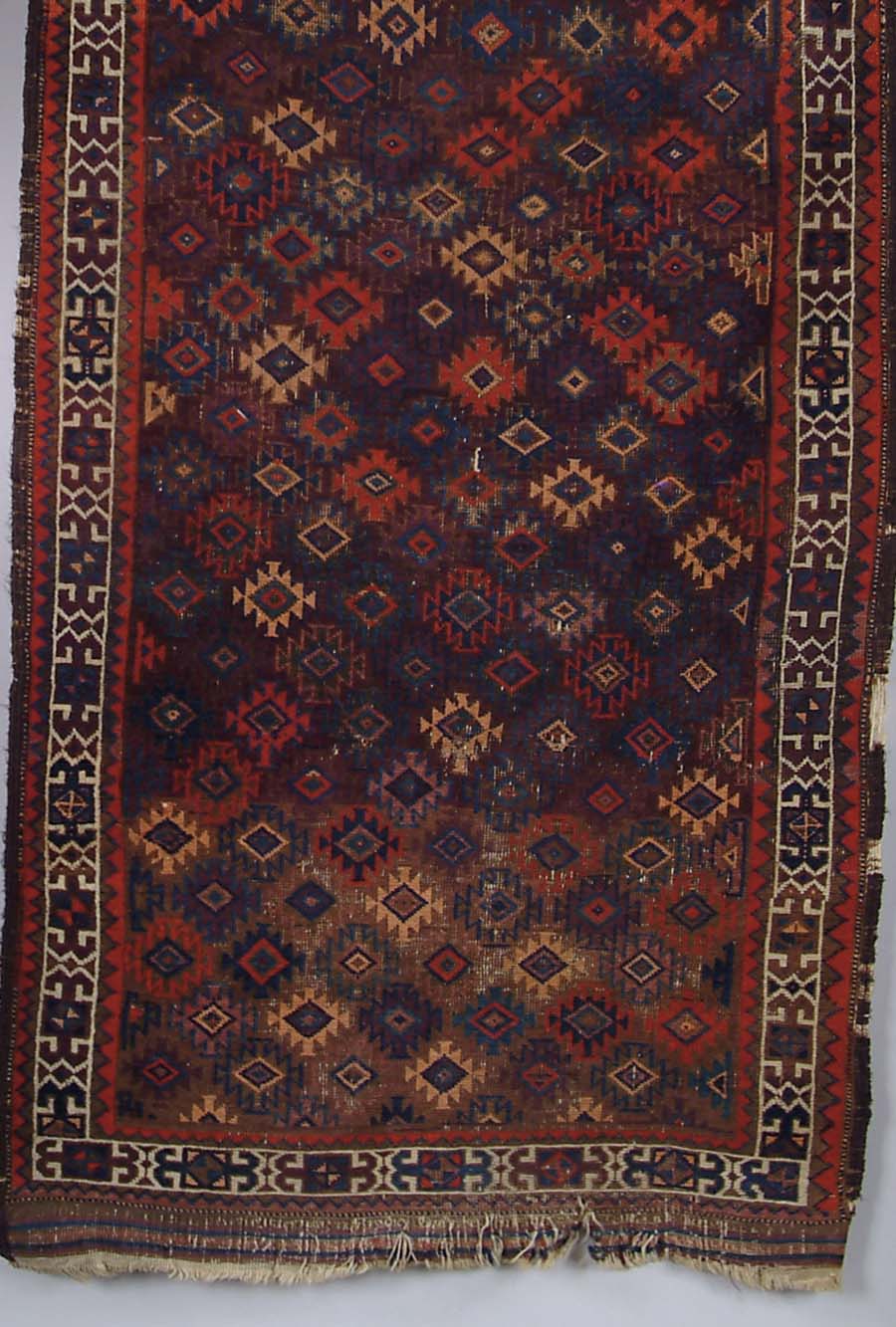 Appraisal: SMALL ORIENTAL RUG Geometric pattern on a brown field with