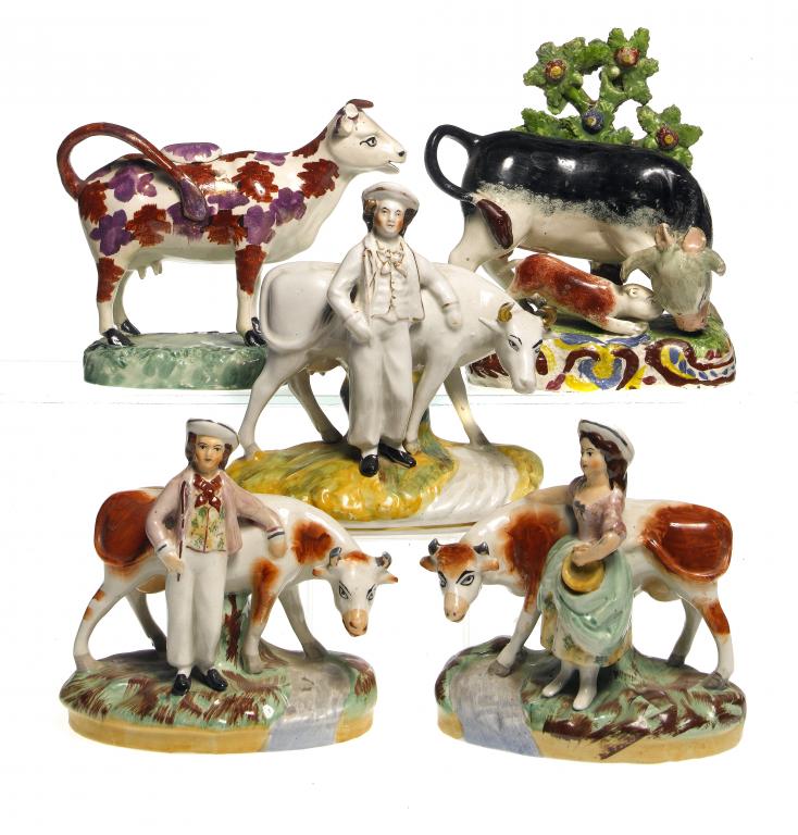 Appraisal: A STAFFORDSHIRE PEARLWARE BULL BAITING GROUP AND COW CREAMER A