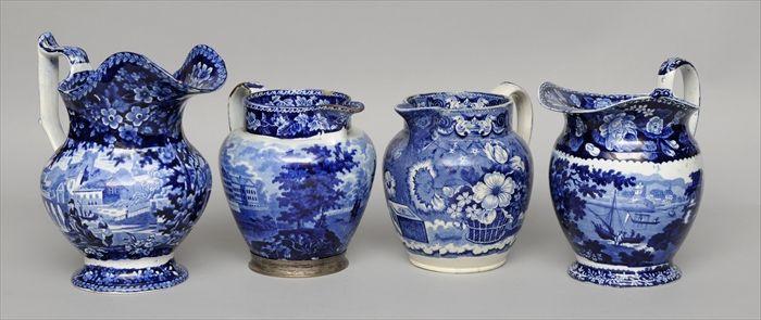 Appraisal: FOUR STAFFORDSHIRE BLUE TRANSFER-PRINTED PITCHERS One with views of the