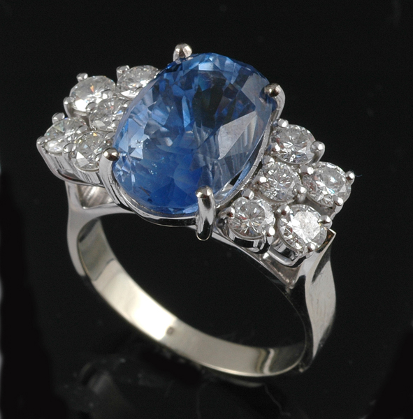 Appraisal: A SAPPHIRE AND DIAMOND RING The oval cut Ceylon sapphire