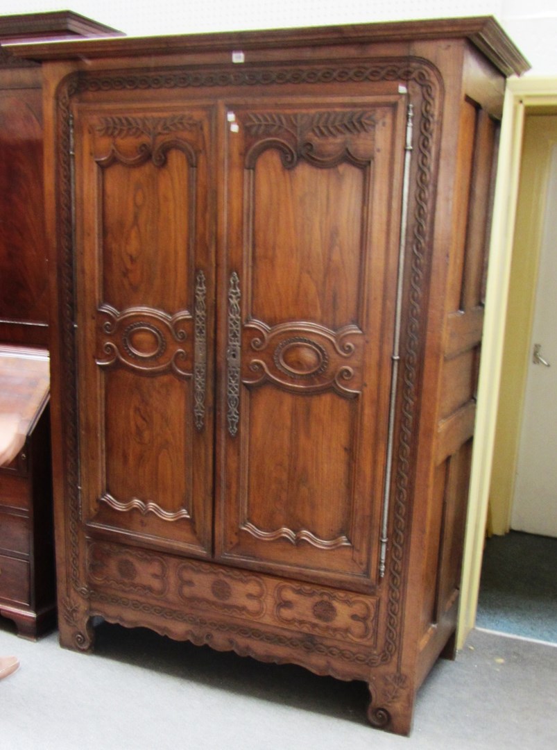 Appraisal: A th century French stained chestnut carved two door armoire