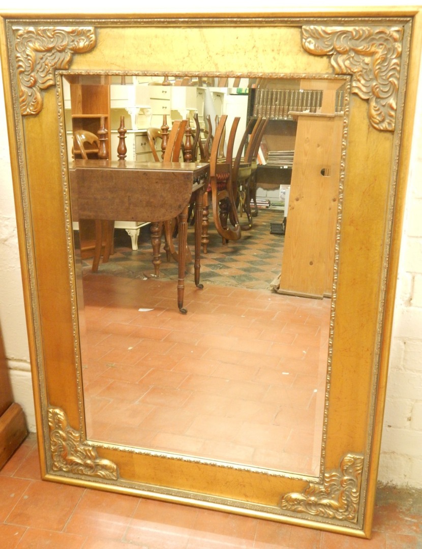 Appraisal: A reproduction gilt gesso wall mirror with a bevelled plate