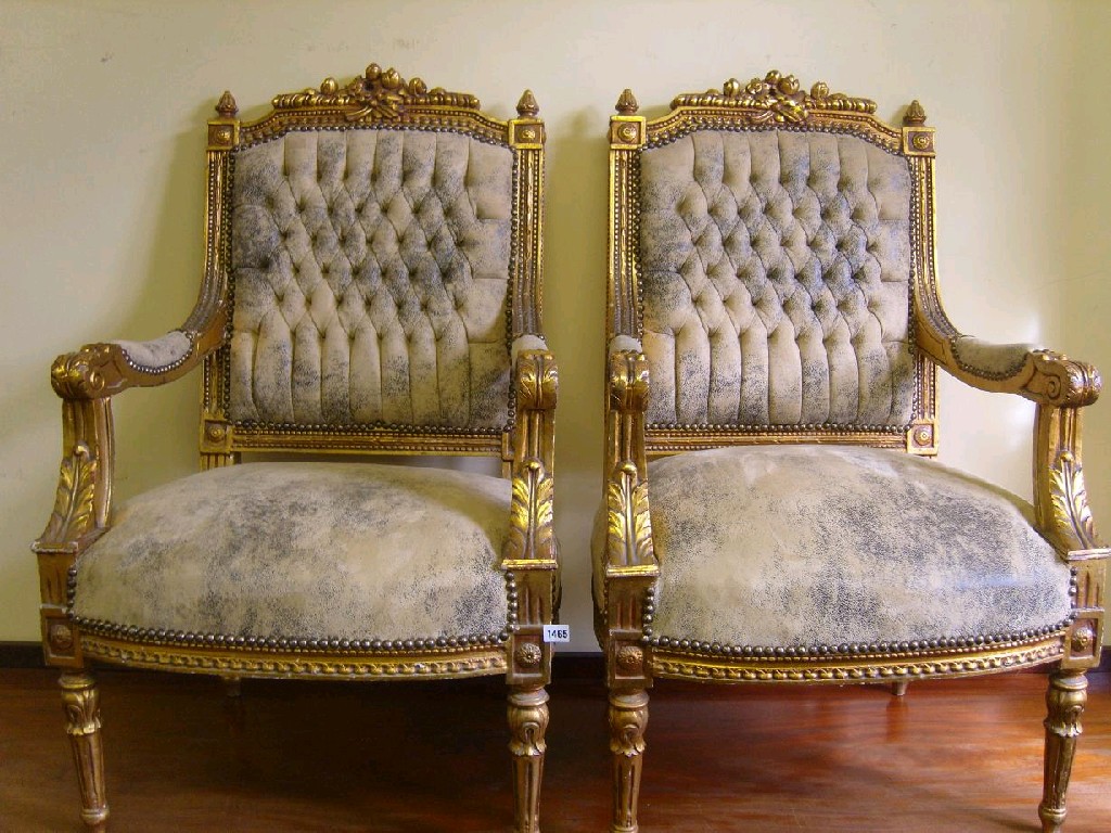 Appraisal: A pair of continental open armchairs with upholstered seats and