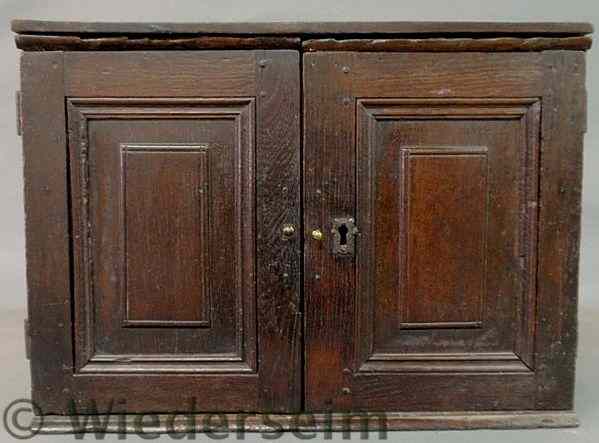 Appraisal: Small English oak cabinet th c with raised panel doors