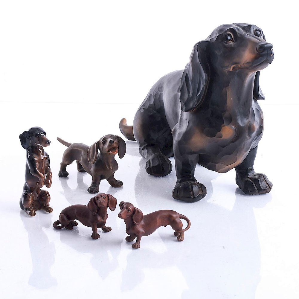 Appraisal: DACHSCHUND DOTSON DOG FIGURINES Four carved wood one Karl Ens