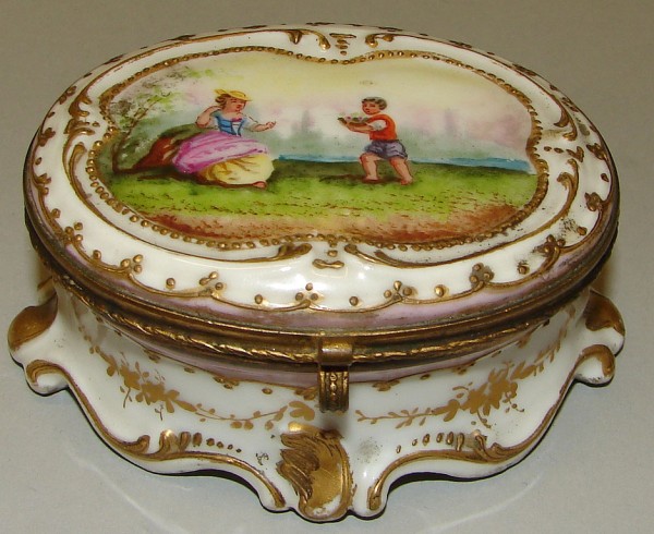 Appraisal: Oval porcelain box features scene with woman receiving flowers from