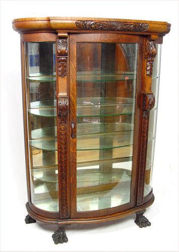 Appraisal: TIGER OAK CARVED TRIPLE BOW CHINA DISPLAY CABINET Veneers and