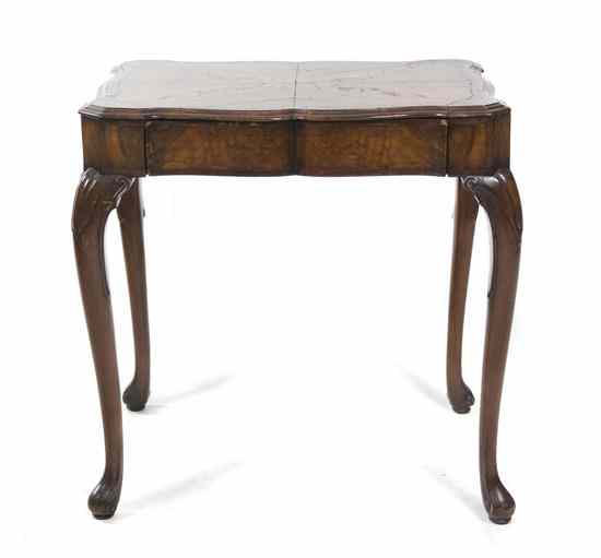 Appraisal: A Continental Burlwood Occasional Table having a shaped rectangular top