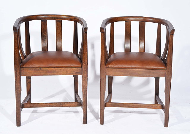 Appraisal: Arts CraftsA pair of oak armchairs circa carved and shaped