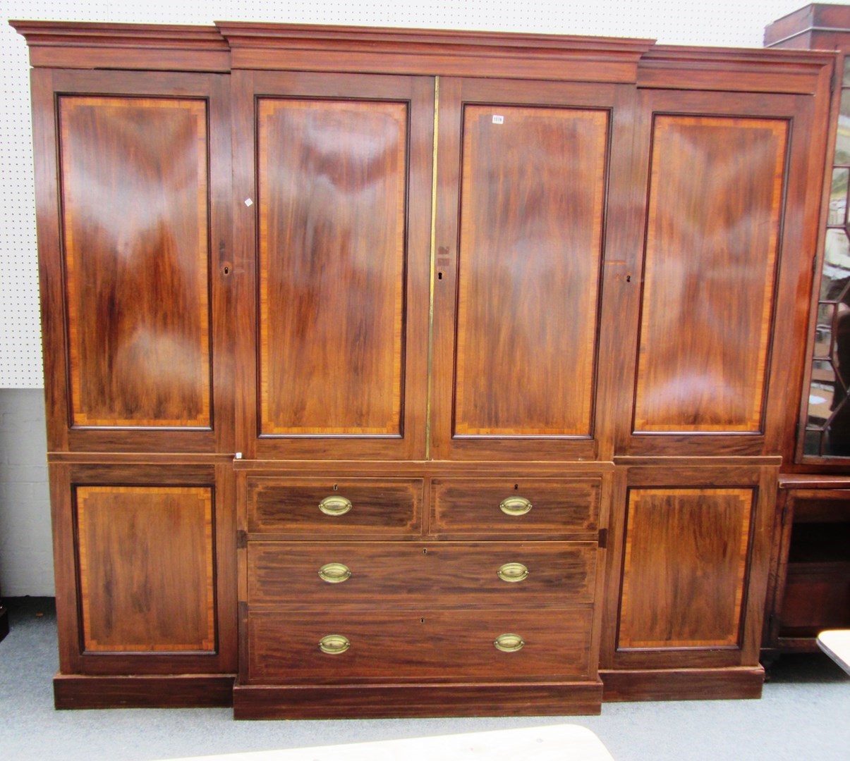 Appraisal: An Edwardian mahogany and crossbanded breakfront wardrobe the projecting cornice