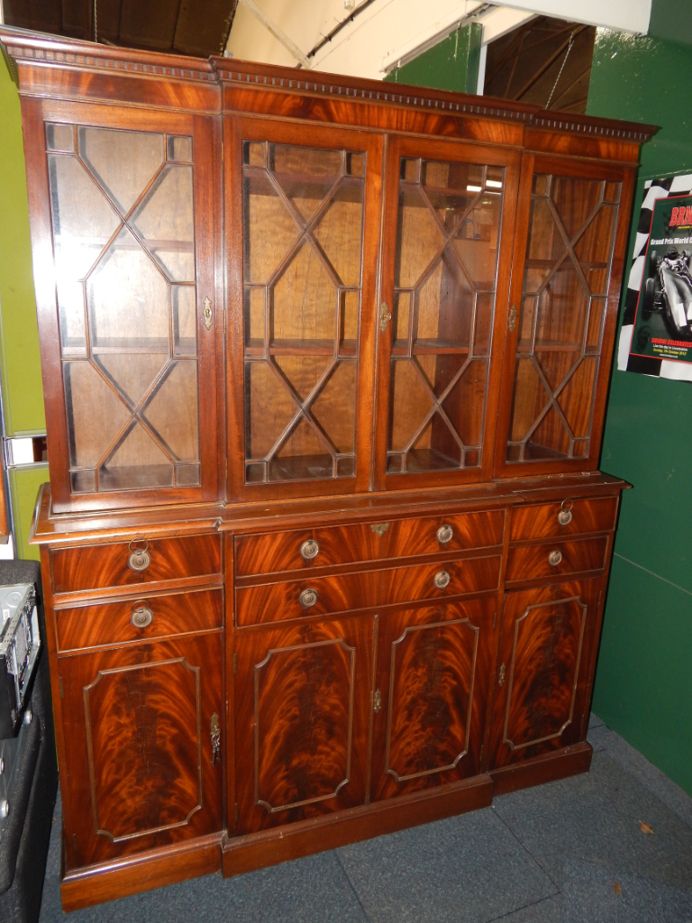 Appraisal: A reproduction mahogany breakfront secretaire bookcase the dentil moulded cornice