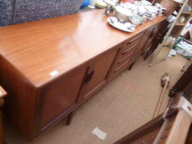 Appraisal: A G-PLAN TEAK SIDEBOARD with four central drawers flanked by