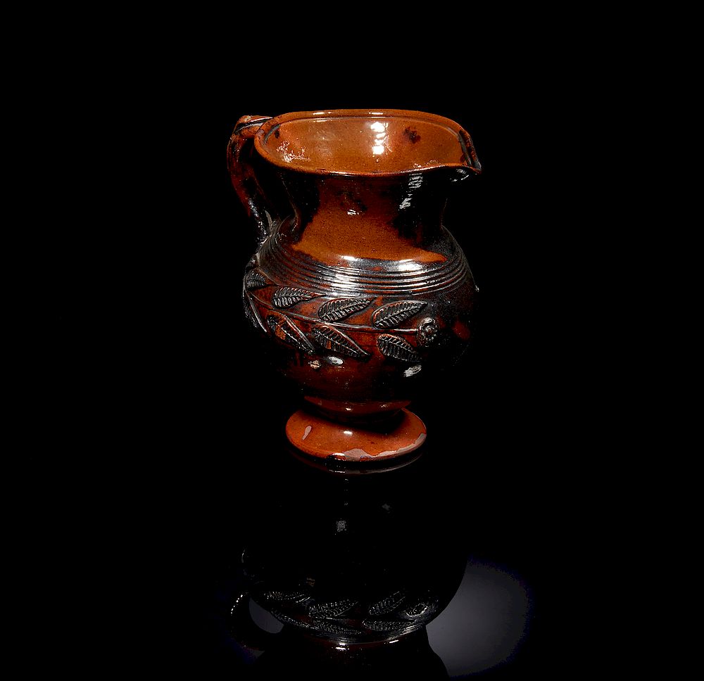 Appraisal: Redware Pitcher Footed redware pitcher with applied floral and serpent