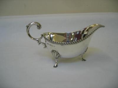 Appraisal: A SAUCE BOAT of oval form with gadrooned rim and