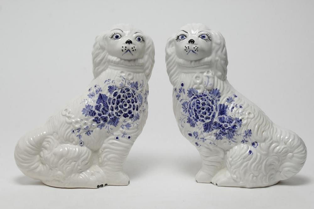 Appraisal: Italian Porcelain Blue White Seated Dogs Pair Italian porcelain blue