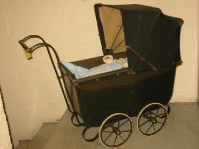 Appraisal: A doll's pram with painted and lined wood body leather