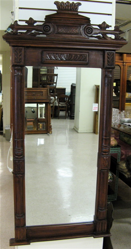 Appraisal: A VICTORIAN STYLE WALL MIRROR Half columnar sides with carved