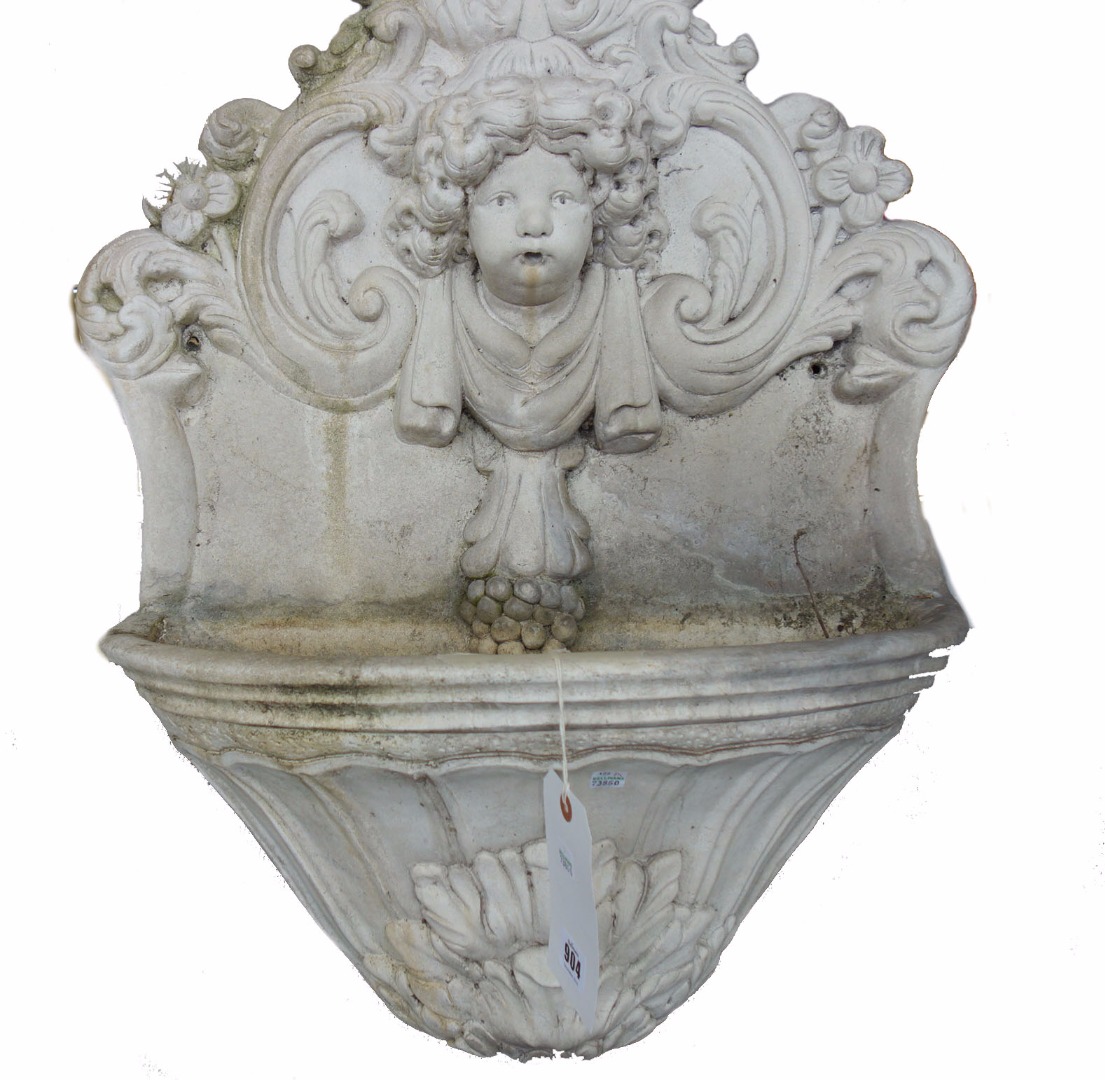 Appraisal: A reconstituted white marble water stoop with relief carved cherub