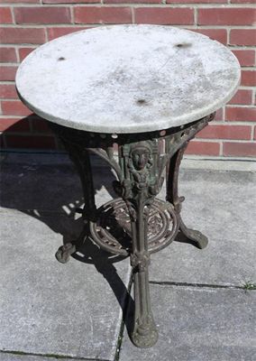 Appraisal: A Victorian cast iron and marble top garden table the