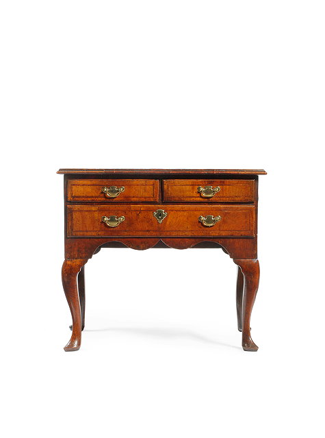 Appraisal: AN TH CENTURY WALNUT AND FEATHER BANDED LOW BOY with