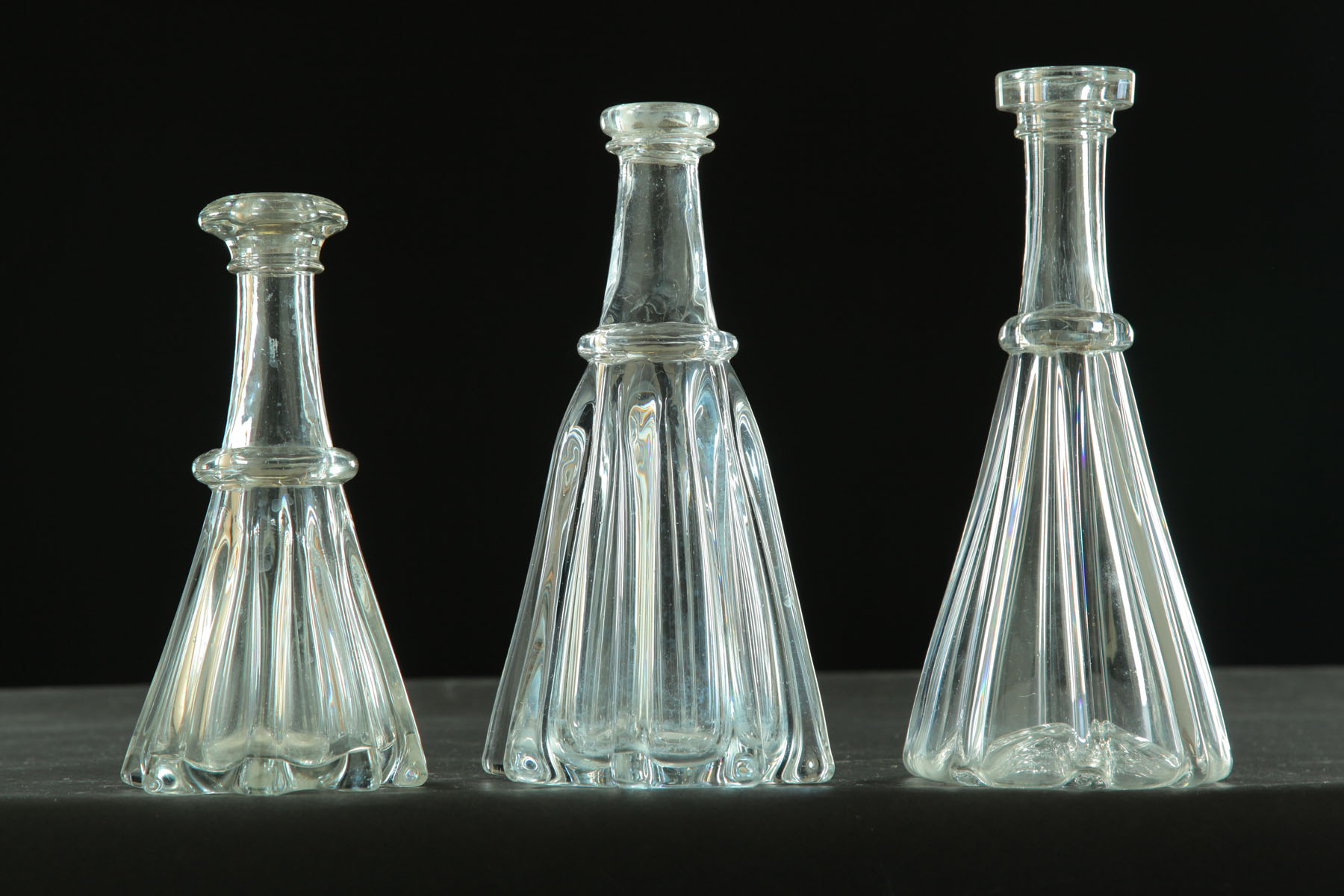 Appraisal: THREE PILLAR MOLD BOTTLES Pittsburgh mid th century clear blown