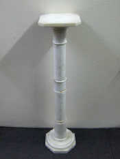 Appraisal: A turned white marble stand with cut corner square top